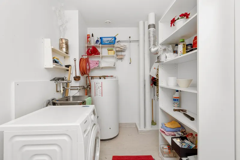 Clean laundry room with a newly installed water heater